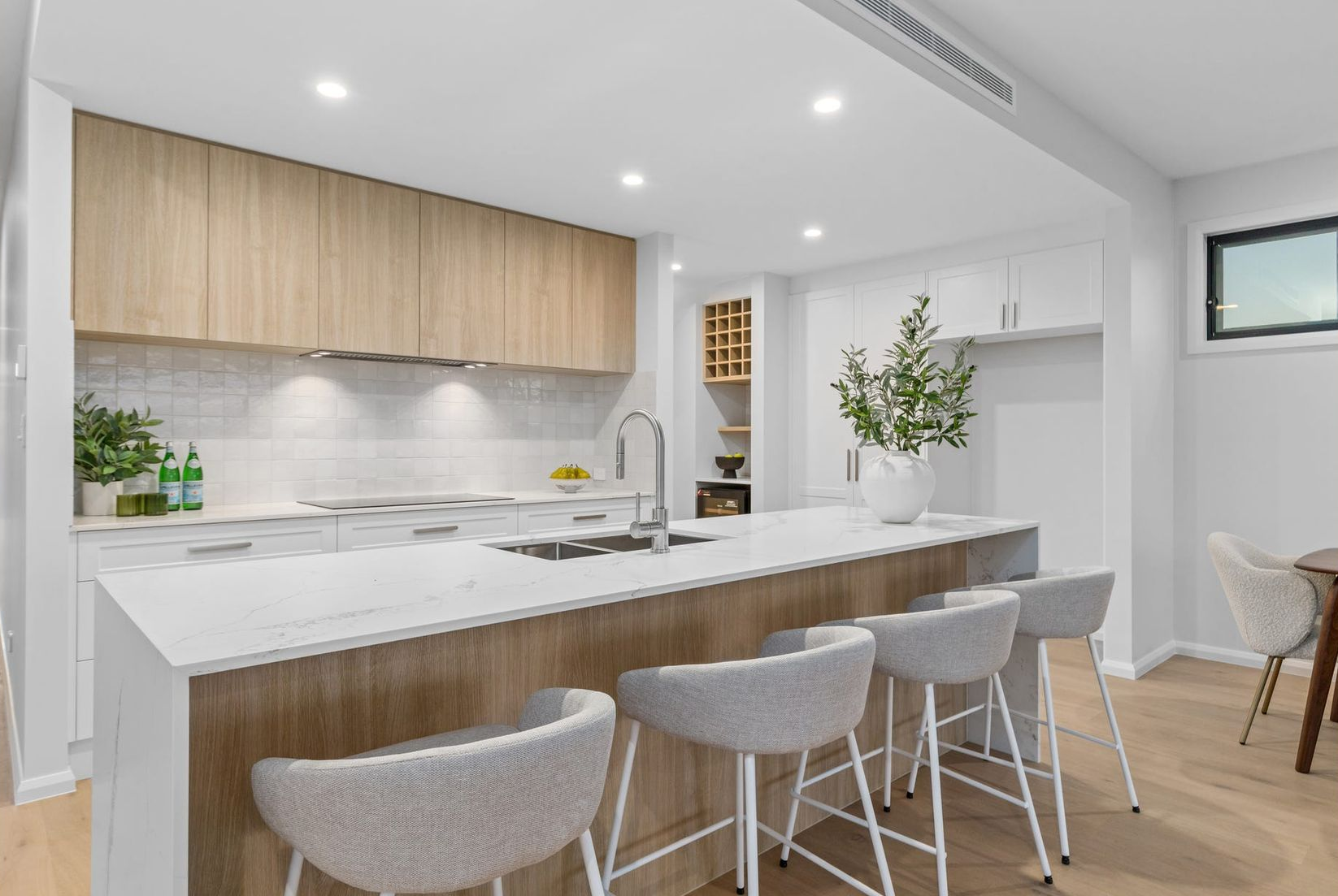 Kitchen under construction with white cabinets, subway tile backsplash, and tools on countertop. — Intolec Electrical In Tweed Heads, NSW