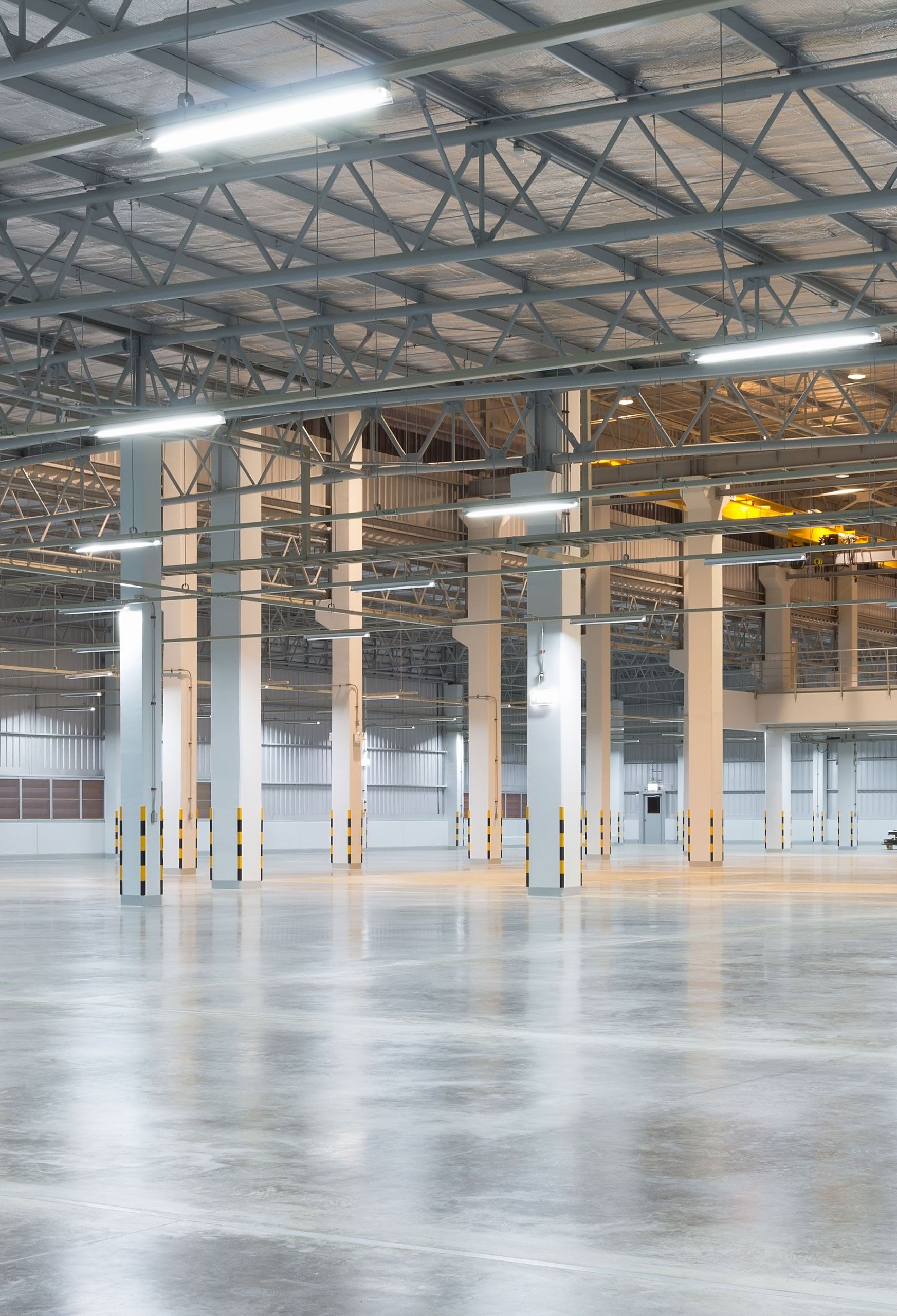 Empty Industrial Warehouse With Concrete Floor and Metal Supports — Intolec Electrical In Tweed Heads, NSW