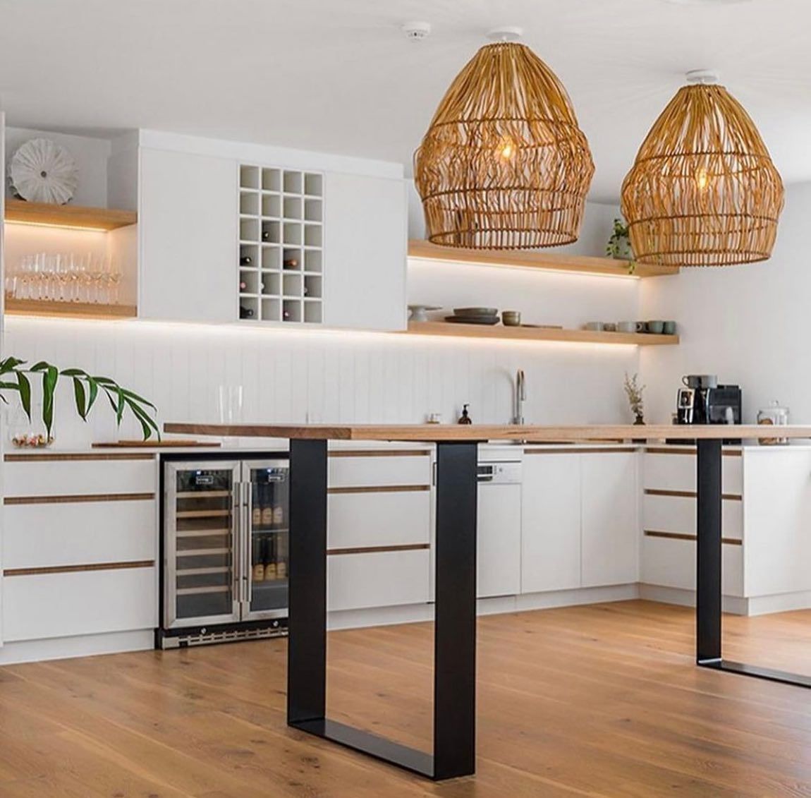 Modern kitchen with wooden bar, white cabinets, and woven pendant lights. — Intolec Electrical In Tweed Heads, NSW