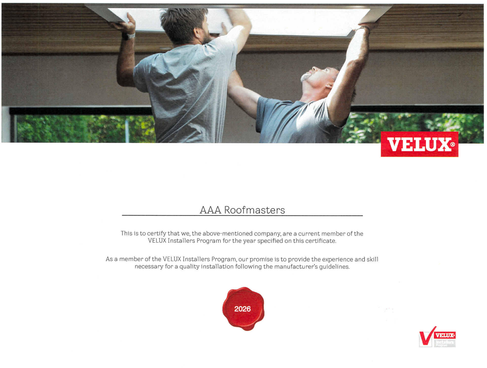 Two men installing a VELUX skylight above a room, with product information below
