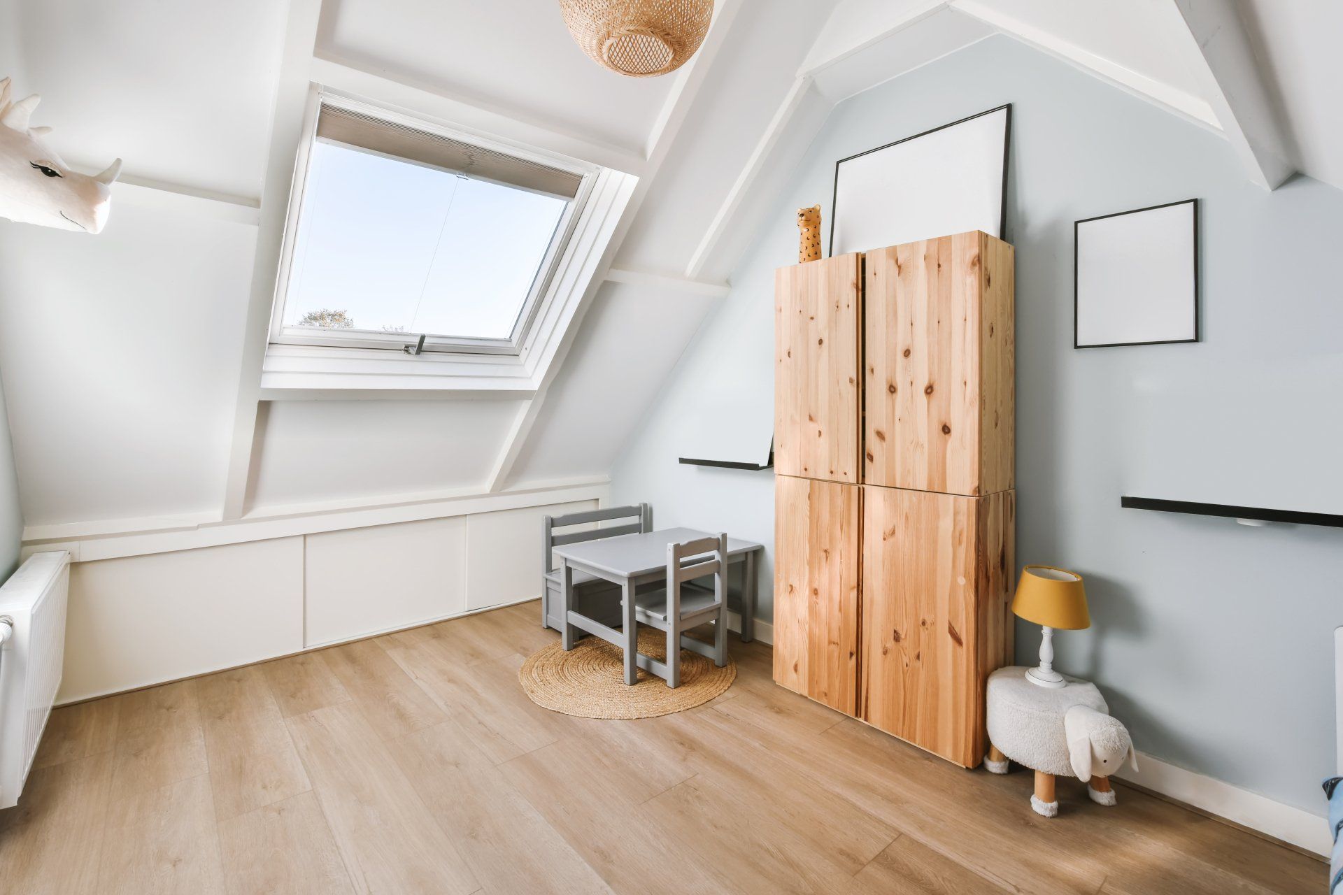 A room with a table and chairs in it and a skylight.