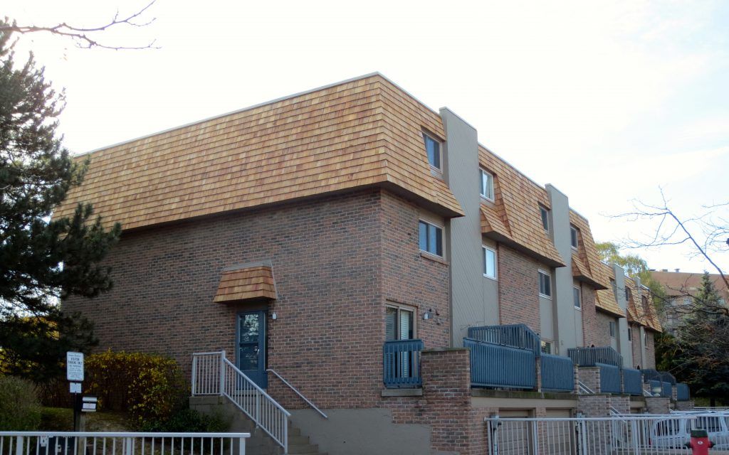 A brick apartment building with stairs leading up to it