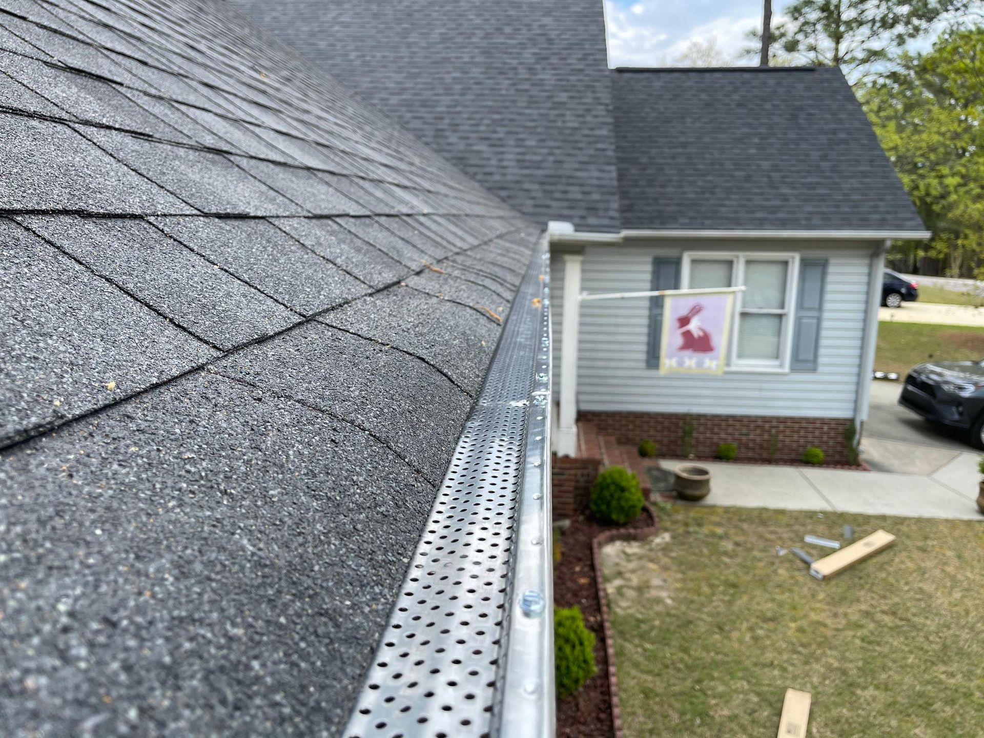 A house with a gutter on the side of it.