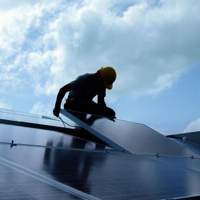 Solar panels being installed on a pitched roof.