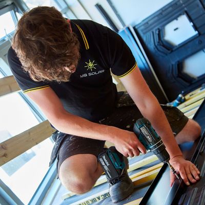 MB Solar team member demonstrates solar panel installation at the MB Solar training centre.