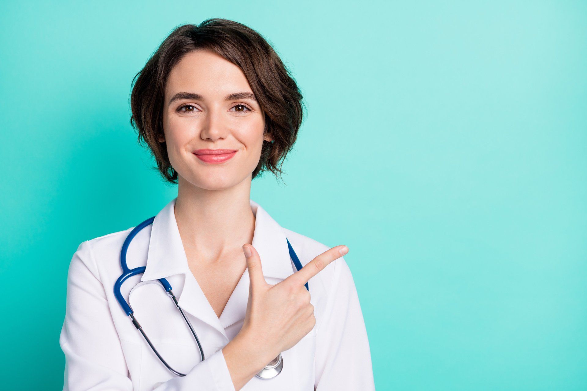 A female doctor is pointing at something with her finger.