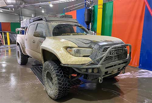 Driver using self car cleaning bay in Calgary