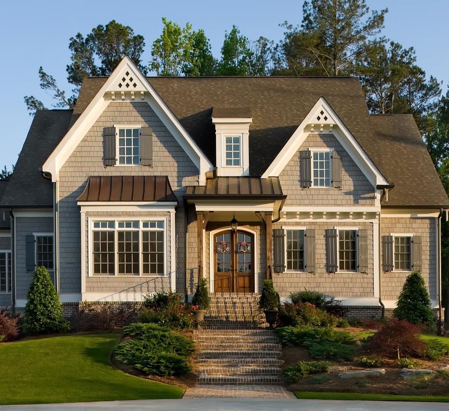 A large house with stairs leading up to the front door A large house with stairs leading up to the front door