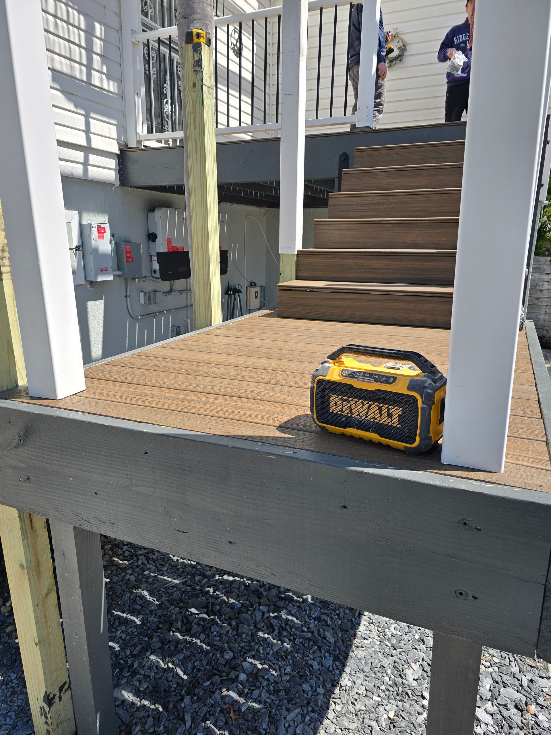 Construction worker’s tool bag on a platform beside stairs and railings