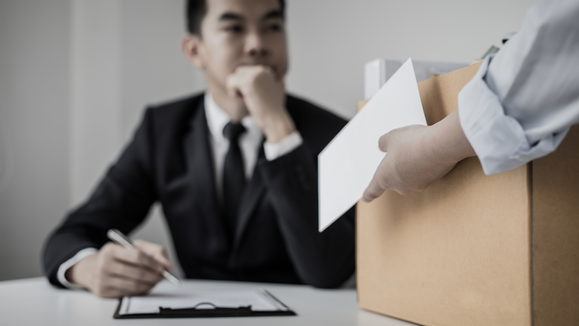 Business advisor handing documents to an entrepreneur during a consultation