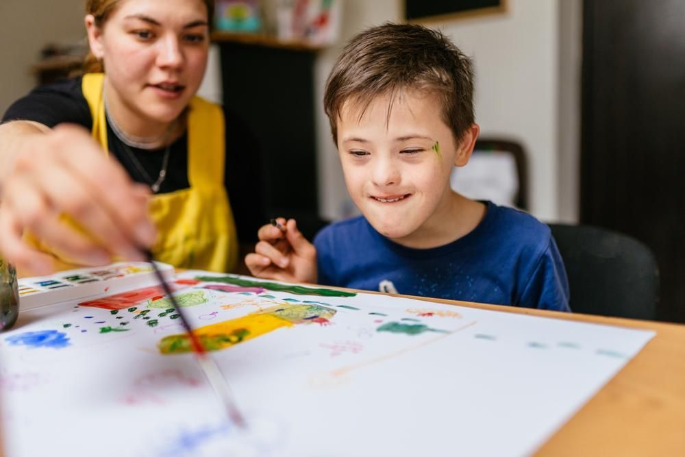 A Woman Helping a Young Boy — Oracle Psychology Child & Adolescent Psychologists Newcastle in Newcastle, NSW