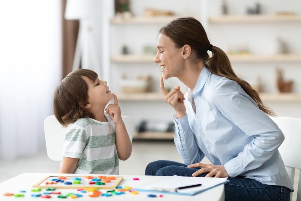 A Woman at A Table Talking to A Little Boy — Oracle Psychology Child & Adolescent Psychologists Newcastle in Newcastle, NSW