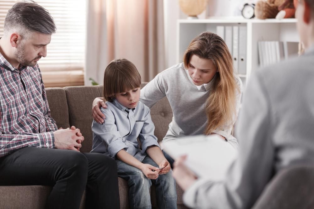 A Family on A Couch Talking to A Counselor — Oracle Psychology Child & Adolescent Psychologists Newcastle in Newcastle, NSW