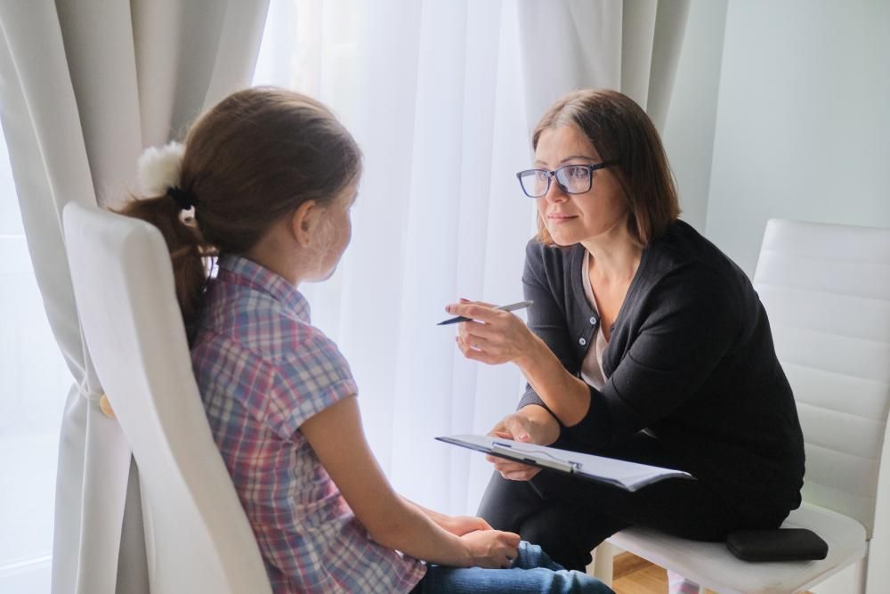 A Woman in A Chair Talking to A Girl — Oracle Psychology Child & Adolescent Psychologists Newcastle in Newcastle, NSW