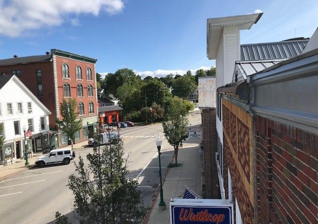 An aerial view of a city street with a sign that says whitshop