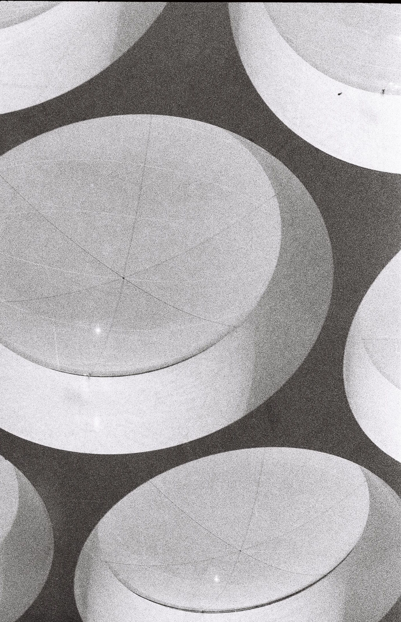 Abstract gray and white circular pattern on a dark background