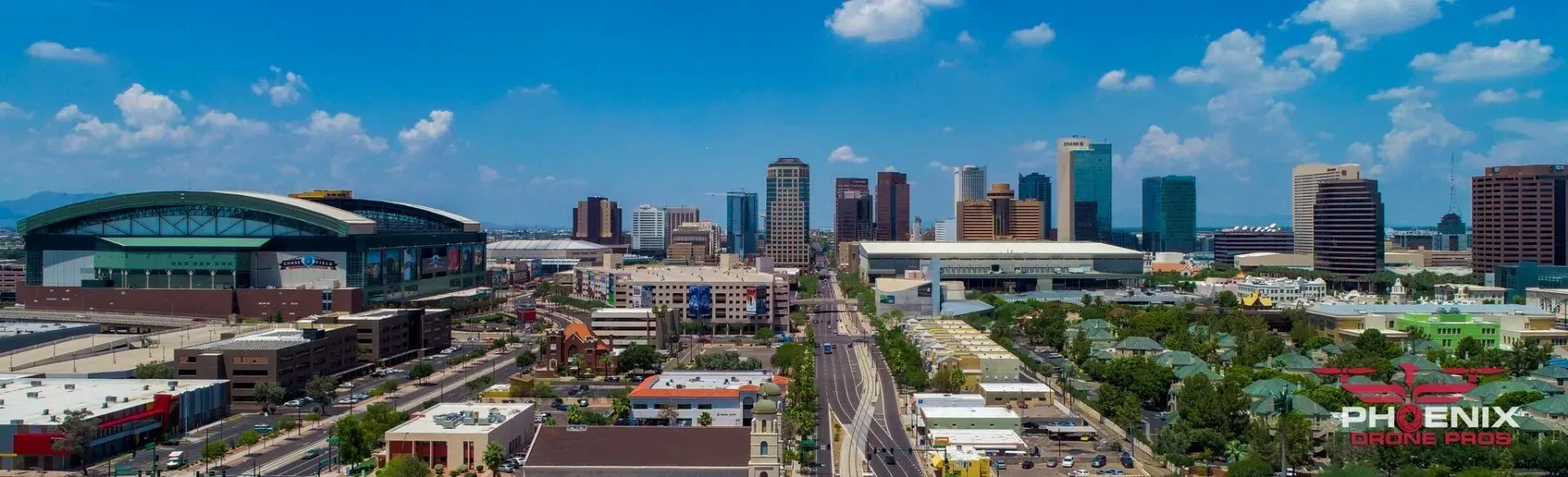 Photo by Phoenix Drone Pros, Robert Biggs, An aerial view of a city skyline on a sunny day.