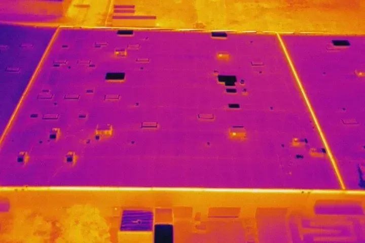 Photo by Phoenix Drone Pros, Robert Biggs, An aerial view of a building with a lot of solar panels on the roof.