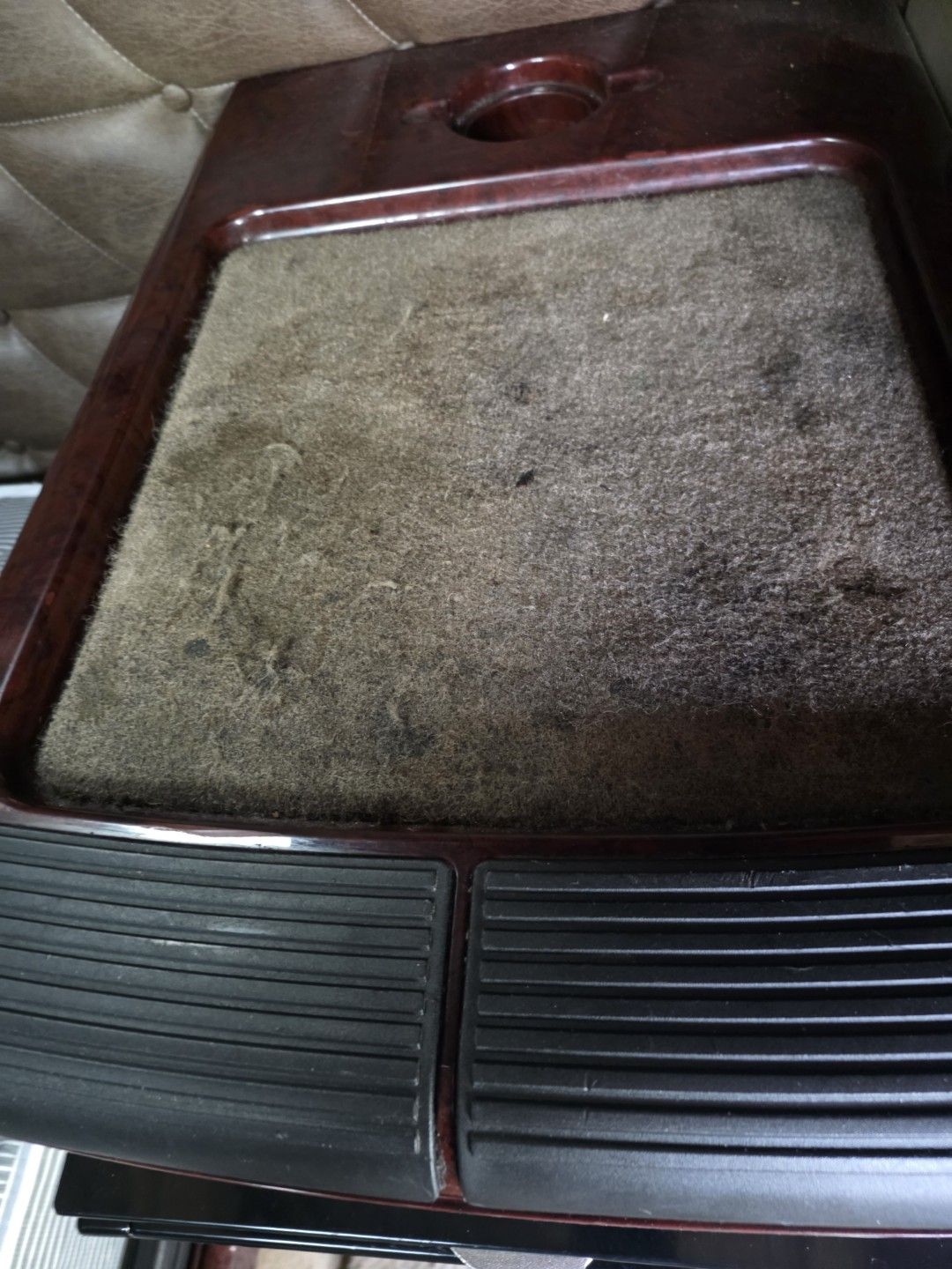 Soiled, matted carpet on a semi truck sleeper step cabinet in Largo, FL, before carpet cleaning