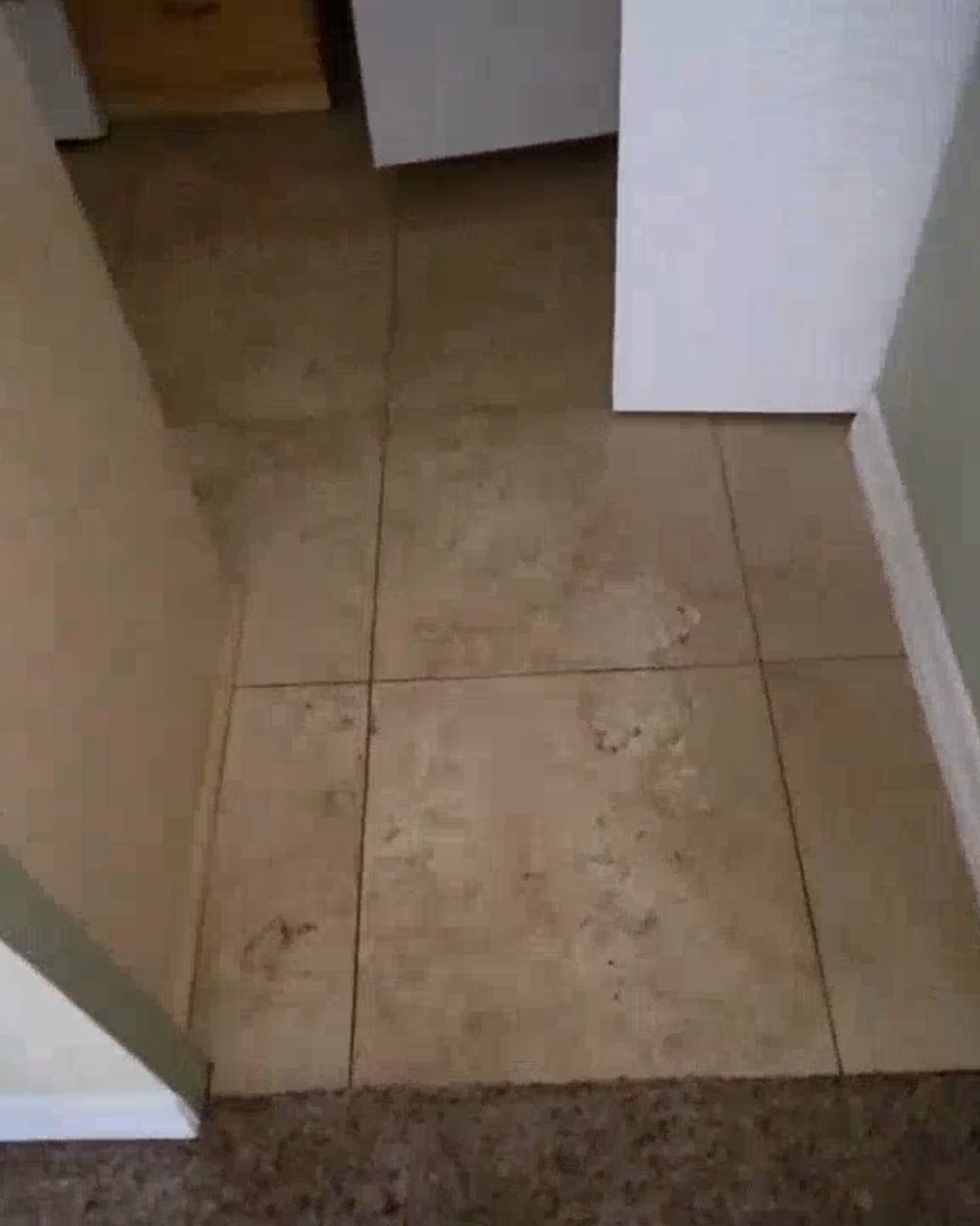 Storm silt and Gulf sand left on a tile floor after Hurricane Helene flooding