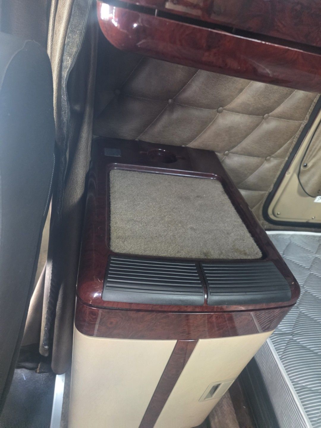 Brighter, more even carpet on a semi truck sleeper step cabinet after carpet cleaning in Largo, FL
