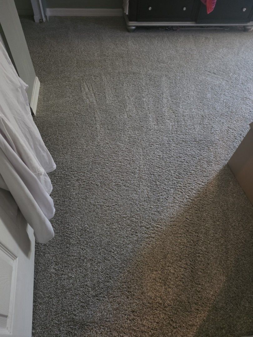 Restored bedroom doorway carpet with clean groomed rows after professional restoration
