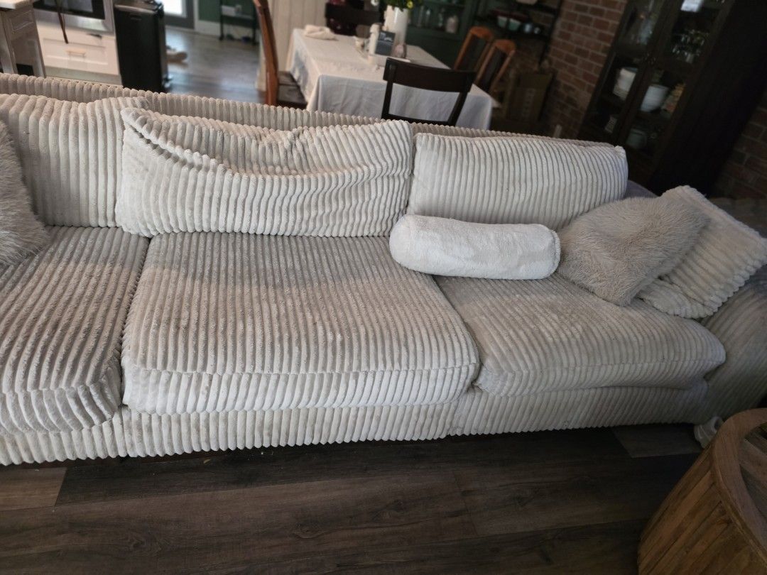 Dingy white sectional sofa in a St. Petersburg living room before professional upholstery cleaning