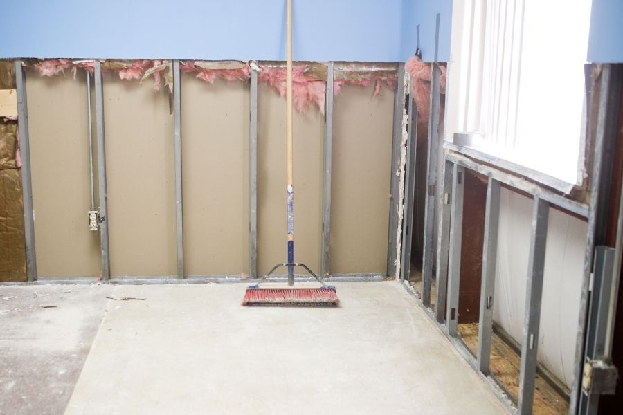 Lower drywall cut away on two walls to expose metal studs and insulation after water damage in a Largo FL room