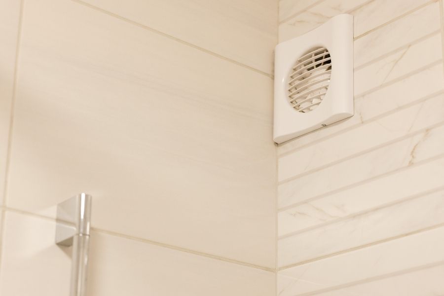 White wall mounted exhaust fan vent in a tiled bathroom in St. Petersburg FL