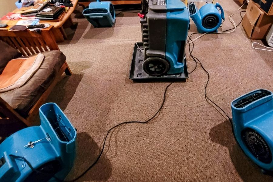 Industrial dehumidifier and air mover running in a Florida home after water damage cleanup