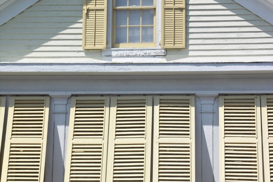Florida home with storm shutters installed and yard cleared ahead of an approaching hurricane