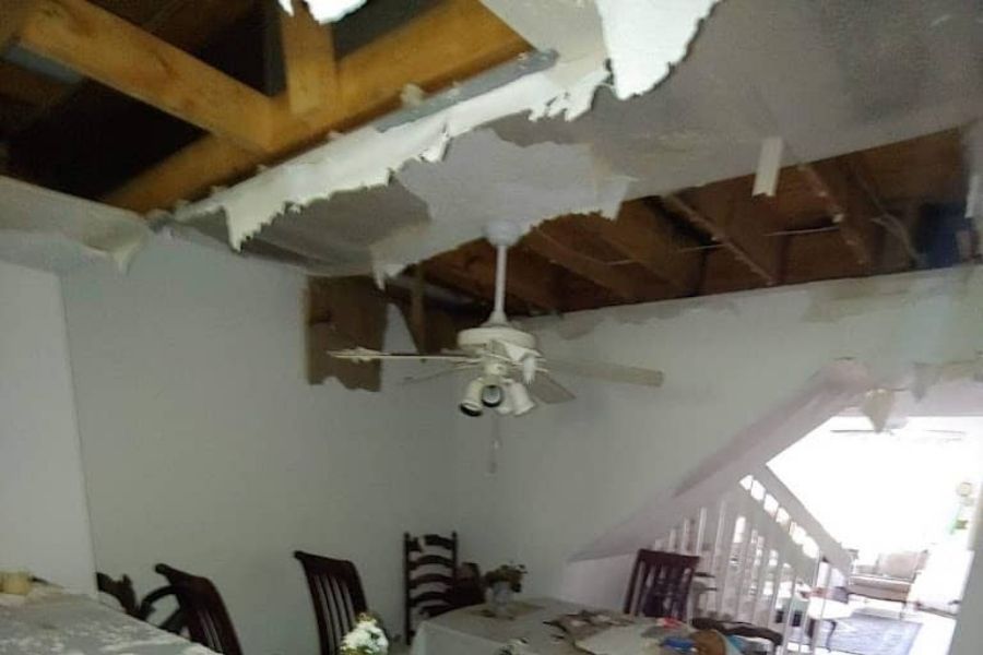 Ceiling water damage staining after a storm showing moisture intrusion