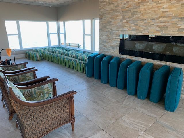 Wicker chairs with freshly cleaned cushions at a Dunedin, FL clubhouse