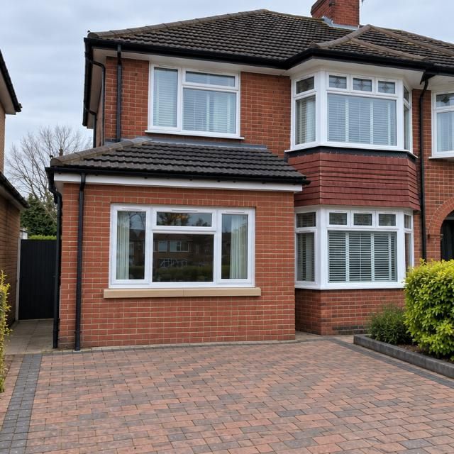 After: Semi-detached house where the garage door has been replaced with brickwork and a window
