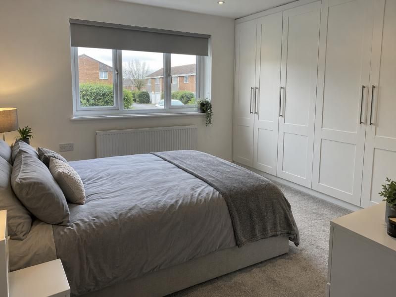 Garage turned into a double bedroom with fitted wardrobes and a new front window