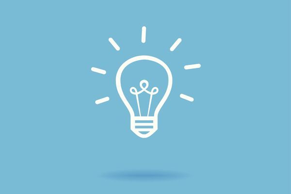 a light bulb with rays coming out of it on a blue background .