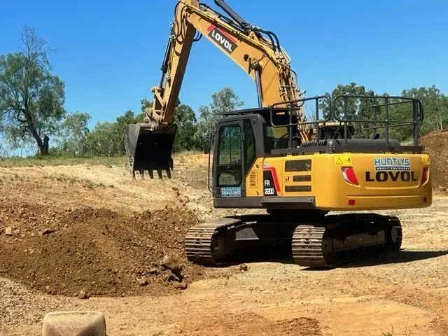 Yellow LOVOL Excavator Digging Dirt on a Sunny Day — Huntlys Heavy Equipment In Gracemere, QLD