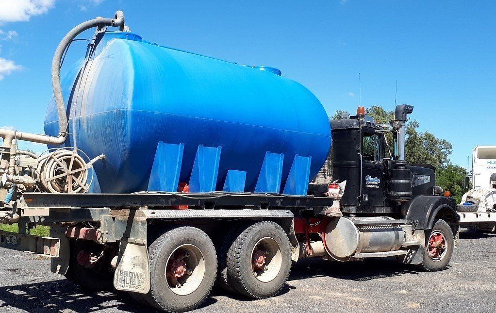 Blue Water Tank Truck Parked Outdoors on a Sunny Day — Huntlys Heavy Equipment in Gracemere, QLD