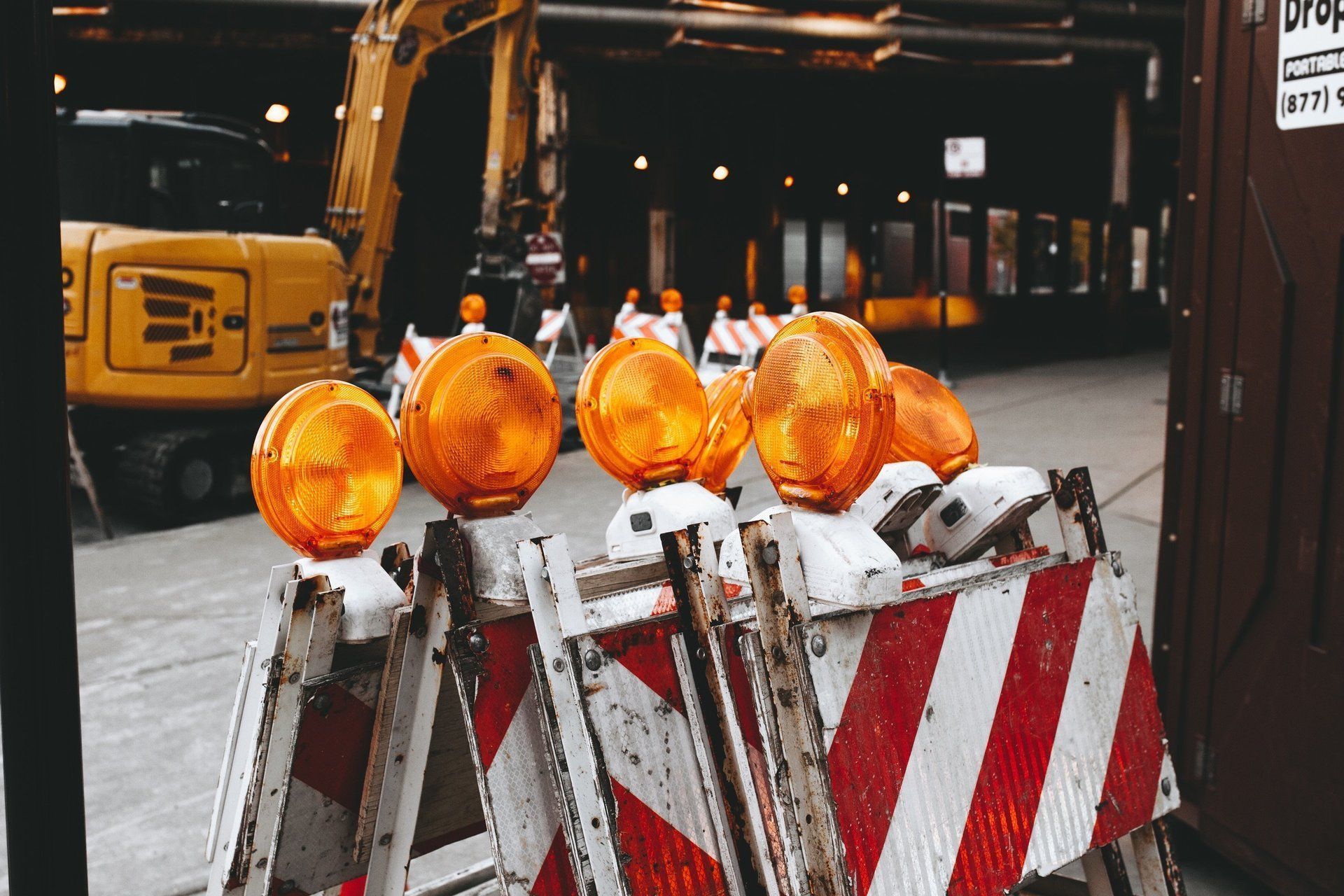 Construction Zone With Flashing Orange Lights Atop Barricades — Huntlys Heavy Equipment in Gracemere, QLD