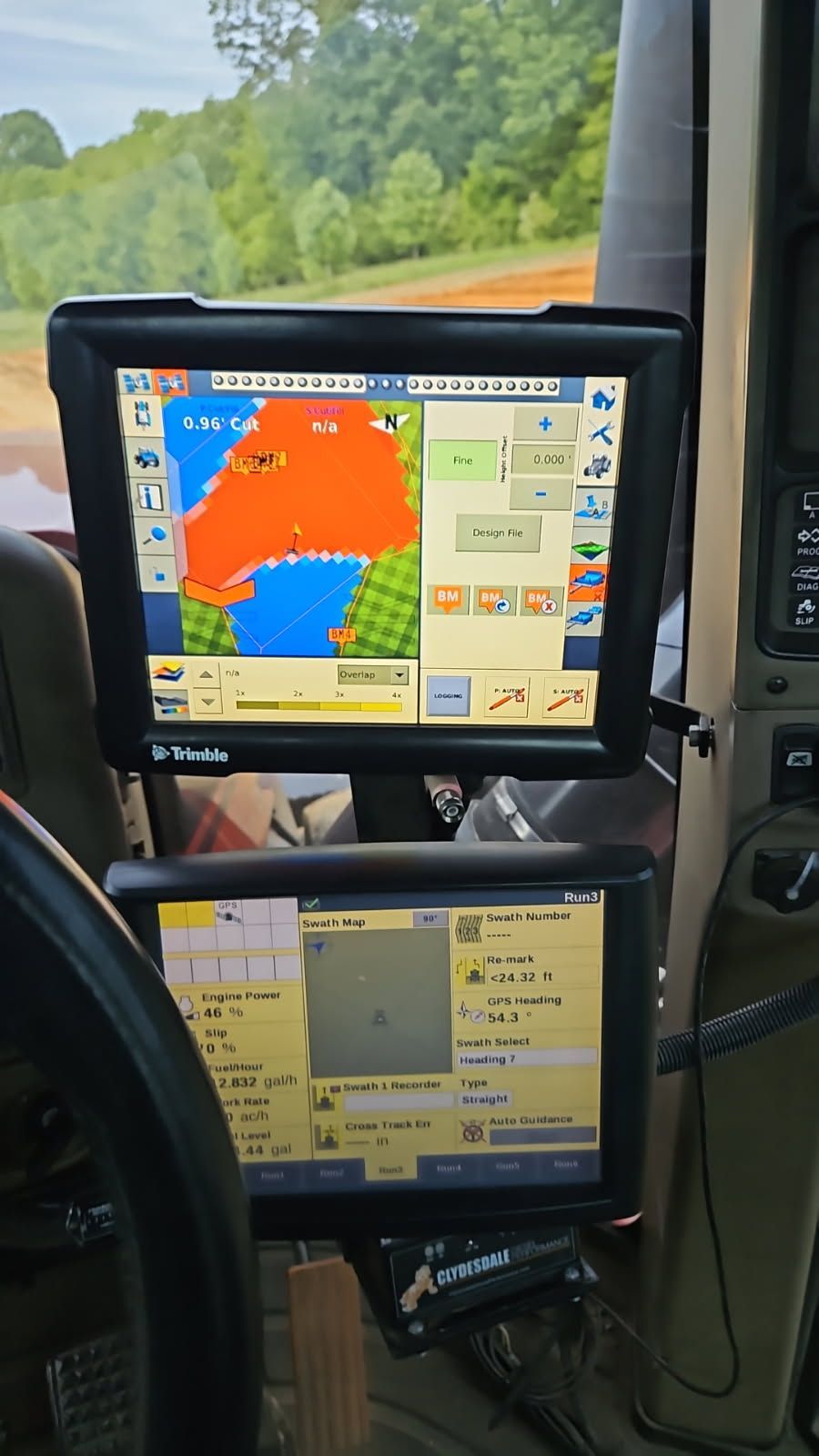 Two stacked vehicle navigation screens showing map data and controls inside a cab