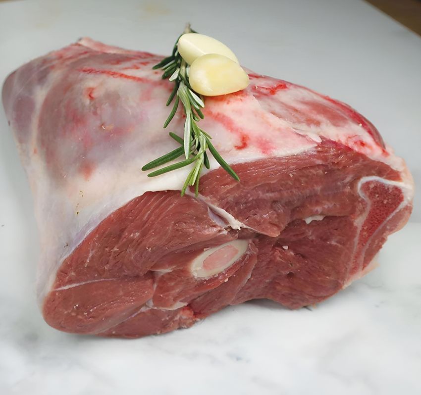 A Piece of Raw Meat with Garlic and Rosemary on Top — Midway Butchers in South Innisfail, QLD