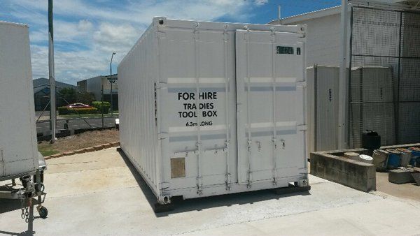 A white shipping container labeled 
