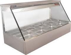 A stainless steel food display case with a glass top and multiple empty metal food pans inside.