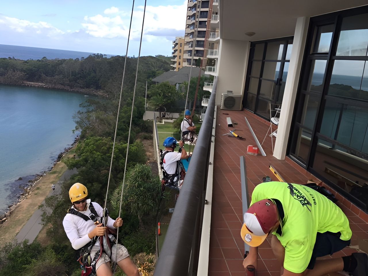 A Group of Men Are Working on a Balcony — Roofing Revamped in Maroochydore, QLD