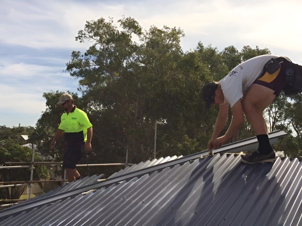 Two Men Are Working on the Roof of a Building — Roofing Revamped in Peregian Springs, QLD