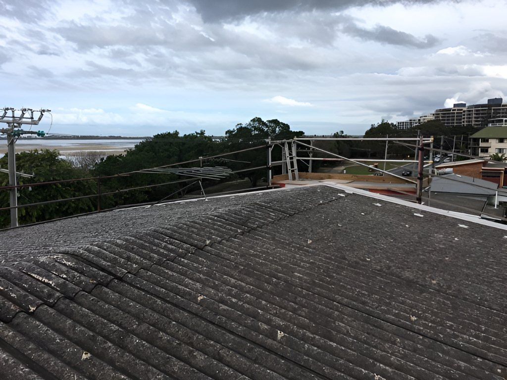 A Roof With A Scaffolding On It And A View Of The Ocean — Roofing Revamped in Marcoola, QLD