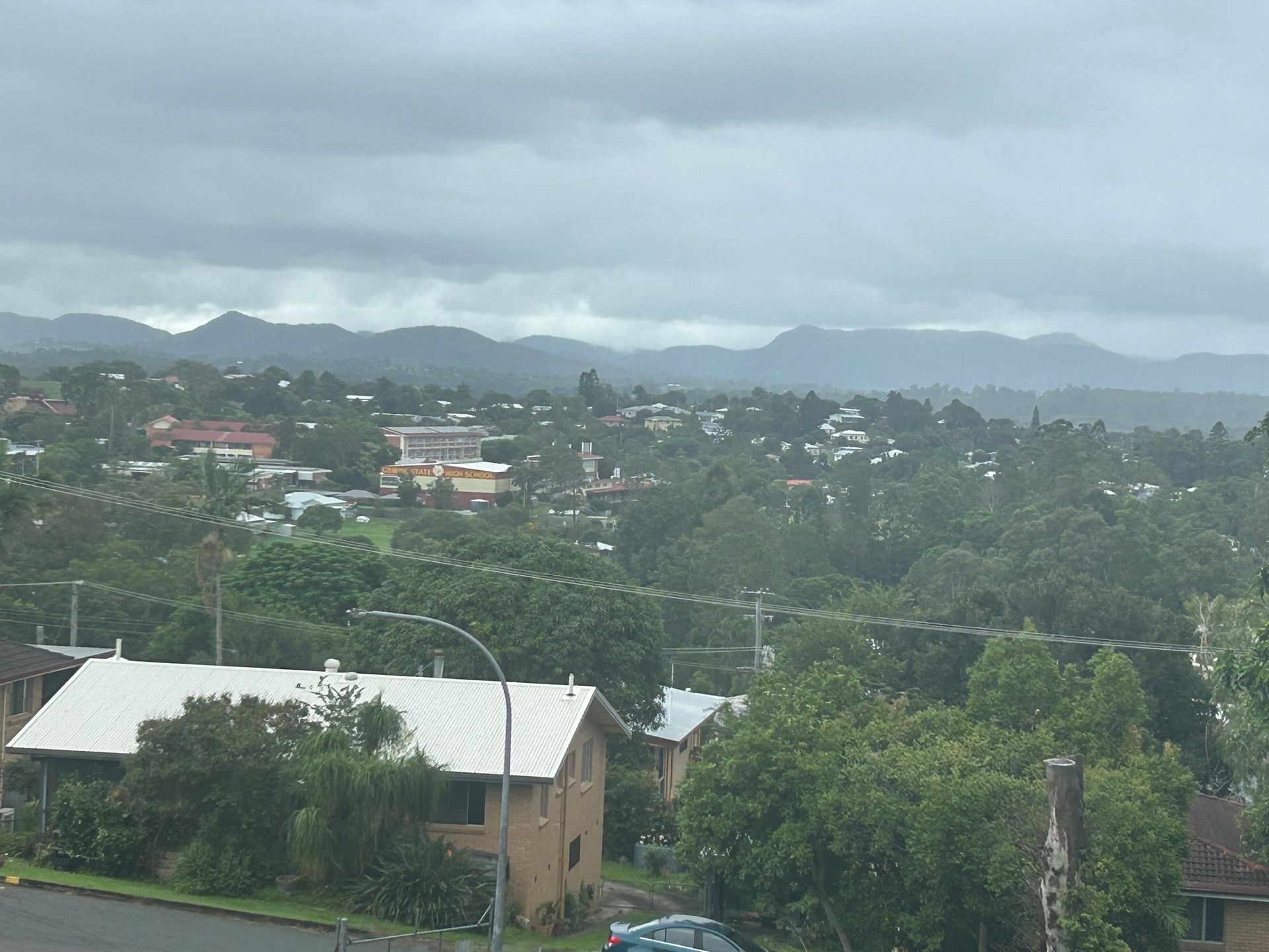 A Man is Working on the Roof of a Building — Roofing Revamped In Gympie, QLD