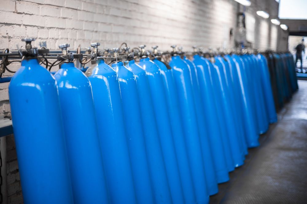 A Row of Blue Gas Tank Lined up In a Room — Eddies Trailers & Fab in Muswellbrook, NSW