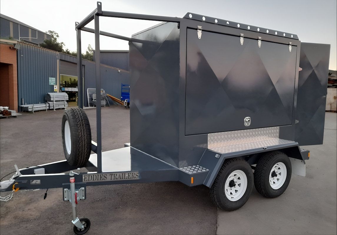 A Trailer with A Box on Top of It Is Parked in A Parking Lot — Eddies Trailers & Fab in Mudgee, NSW