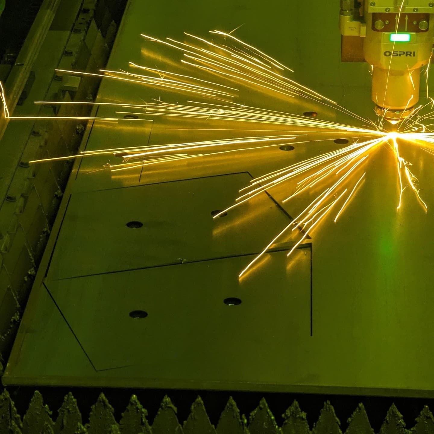 A Laser Cutting Machine Is Cutting a Piece of Metal — Eddies Trailers & Fab in Muswellbrook, NSW